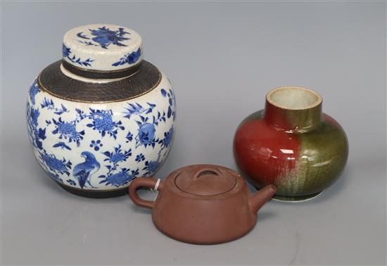 A Chinese squat baluster vase, crackle-glazed in green and red, a blue and white ginger jar and cover and a redware teapot